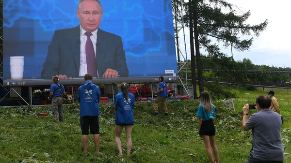 Люди смотрят трансляцию прямой линии с президентом РФ Владимиром Путиным в фанпарке Бобровый лог в Красноярске