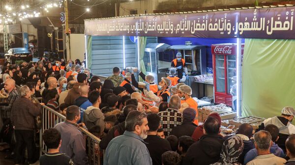 Волонтеры благотворительной организации раздают традиционную предрассветную трапезу Сухур в Рамадан в шиитском районе южного пригорода Бейрута