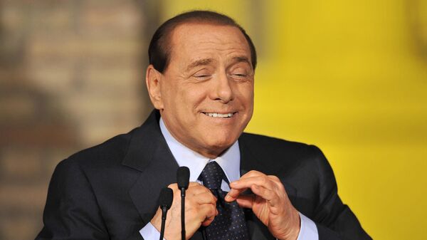 Премьер-министр Италии Сильвио Берлускони поправляет галстук во время пресс-конференции, Италия