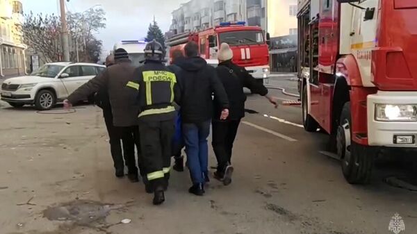 Сотрудники МЧС несут раненого во время атаки ВСУ на Белгород