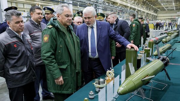 Министр обороны РФ Сергей Шойгу (второй слева) осматривает образцы высокоточных боеприпасов и зенитных управляемых ракет