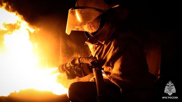 Спасатель тушит пожар на нефтебазе в Ровеньках ЛНР