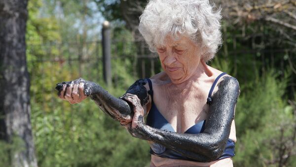 Женщина отдыхающая на Черноморском побережье Крыма в городе Саки, известным своими грязелечебницами. Архивное фото