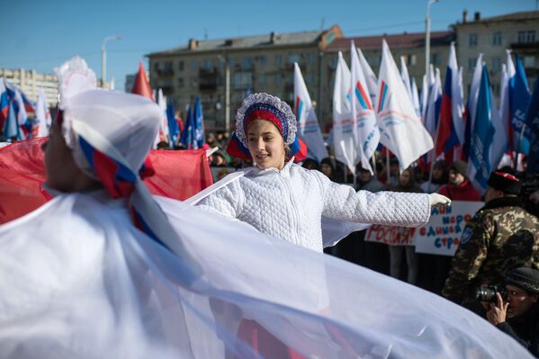 Участники представления во время митинга в честь третьей годовщины воссоединения Крыма с Россией у здания Пушкинской библиотеки в Омске