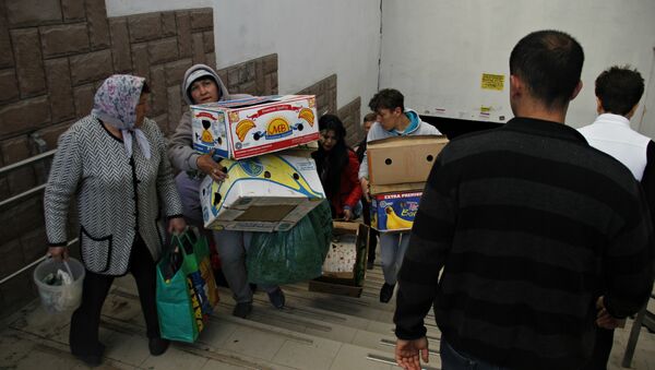 Стихийщики пытаются унести свой товар во время рейда по несанкционированной торговле в Симферополе