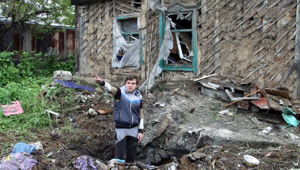 Житель Донбасса демонстрирует последствия обстрела со стороны украинских силовиков. Архивное фото