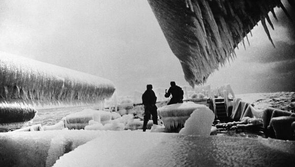 Матросы линкора Севастополь скалывают лед с палубы корабля во время боевого выхода в море