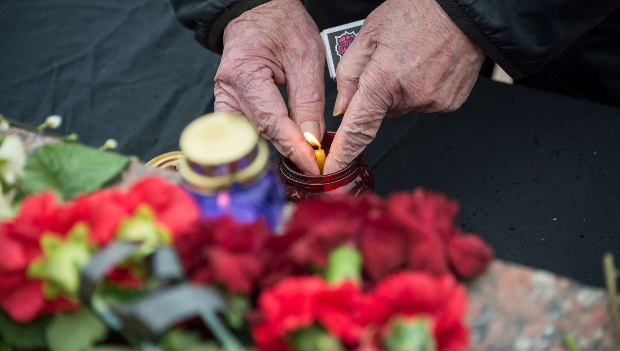 Прощание с погибшими в зимней вишне. Люди несут цветы к сгоревшему танку в Берлине. Будет ли траур по погибшим в крокусе