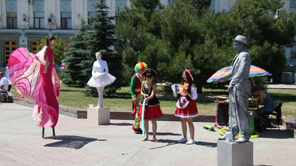 Аниматоры, живые скульптуры и артисты на ходулях развлекают маленьких симферопольцев в честь празднования Дня России на площади им. Ленина