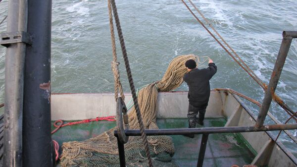 Моряк сейнера Такиль забрасывает трал в Азовское море