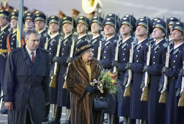Королева Елизавета II и первый вице-премьер РФ Олег Сосковец обходят строй почетного караула во время официальной церемонии встречи в аэропорту. 1994 год