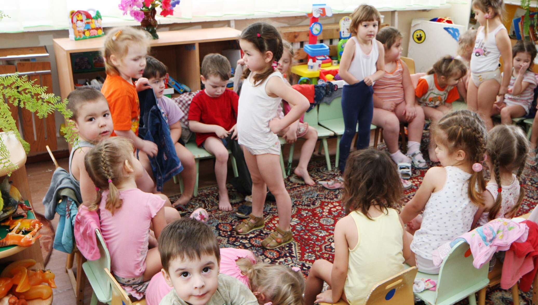 Малыши одеваются в детском саду